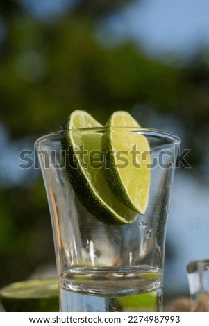 glass on the table with lemon in a sunny day