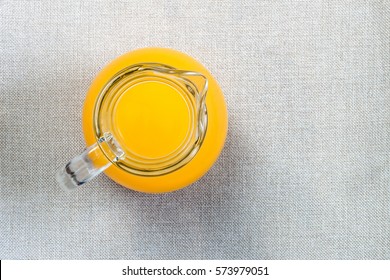 Glass Of Orange Juice From Above, Top View On Burlap Sackcloth Background