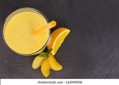 Glass Of Orange Smoothie, Isolated On Slate Plate. Top View.