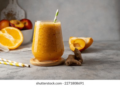 Glass of orange smoothie made with peach, ginger and orange, copy space. - Powered by Shutterstock