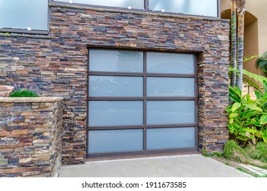 Glass Paned Garage Door And Stone Brick Wall Of House In San Doego California