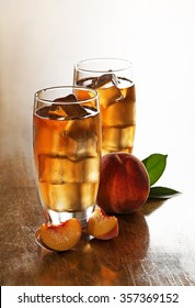 Glass Of Peach Ice Tea With Slices Cubes.