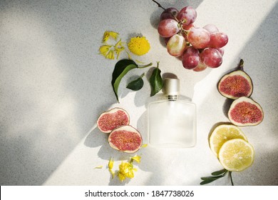 
glass perfume bottle with water drops, lemon and fig wedges on light background with hard shadows. Fresh fruit scent concept. Copy space - Shutterstock ID 1847738026