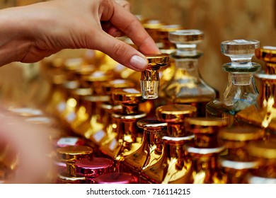 Glass perfume bottles based oils. A Bazaar, market. Macro. Gold and pink gamma