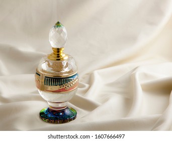 Glass Perfume And Fragrance Bottle On A Fabric.