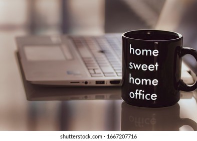 Glass With The Phrase Home Sweet Home Office At Home And The Computer In The Background