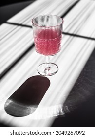 A Glass Of Pink Carbonated Drink