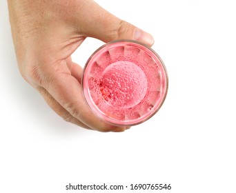 Glass Of Pink Lemonade In Human Hand, Top View