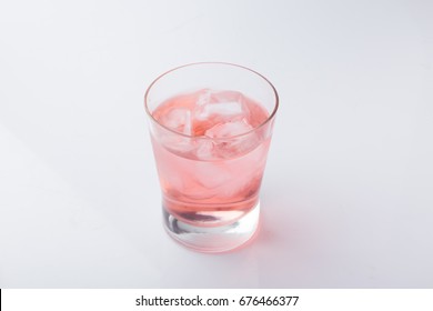 Glass Of Pink Soda Drink With Ice Isolated On White Background