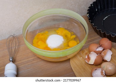 A Glass Plate Filled With Eggs With Yellow Yolks Prepared For Making The Pie At The Farm, Placed On A Table With A Rough Textured Surface.No People Close-up View Of Products. Sugar On The The Top. 