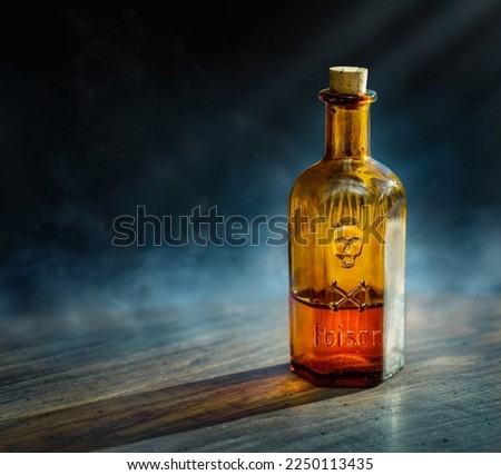 Glass poison bottle with skull and bones. Danger sign Concept on poison poisoning, pharmaceutical, chemistry, medical, old science topic. Poison, venom, toxin, toxic, bane, virus background.