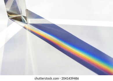 Glass Prism For Optical Physics Experiments In Education, Splitting The Light Into Reflection Beams In The Spectrum Of Rainbow Colors, Bright Background, Copy Space, Selected Focus