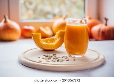 A Glass Of Pumpkin Juice With Pumpkin Seeds On A Windowsill