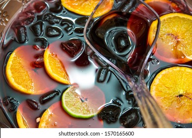 Glass Punch Bowl With Ice, Orange And Lime Slices And Clear Plastic Ladle