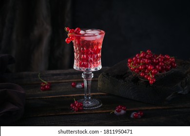 Glass Of Red Currant Cocktail Or Mocktail, Refreshing Summer Drink With Crushed Ice And Sparkling Water On Dark Wooden Background.