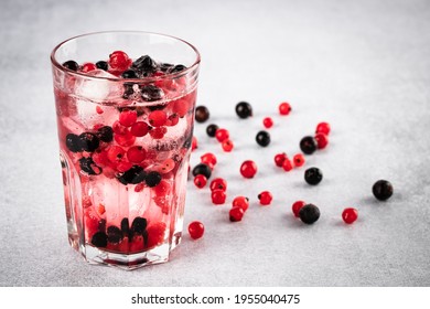 Glass Of Red Currant. Refreshment Summer Drink With Black Currants And Ice Close-up On A Gray Background. Fruitarianism, Veganism Concept. Vegetarian Diet. Berry Lemonade. Colorful Fruits.