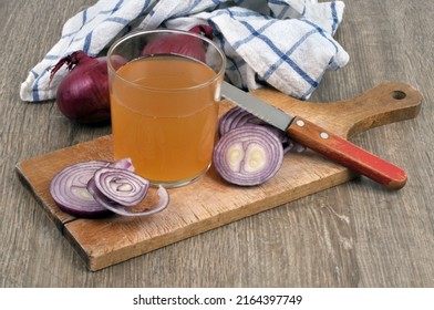 Glass Of Red Onion Juice And Its Ingredients On A Cutting Board