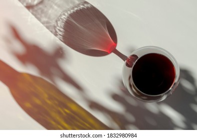 Glass Of Red Ruby Port Wine On White Table With Shadows