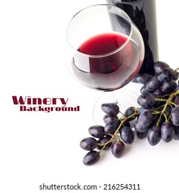Glass of red wine with bunch of grapes  and bottle isolated on white background. Selective focus