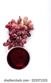 Glass Of Red Wine With Bunch Of Grapes, Overhead On White Background, Minimalist Arrangement