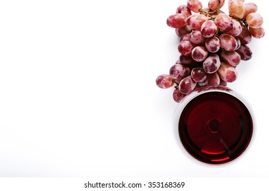 Glass Of Red Wine With Bunch Of Grapes, Overhead On White Background, Minimalist Arrangement