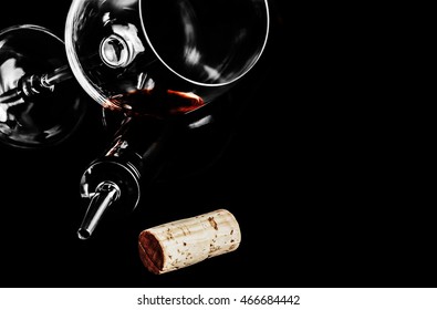 A Glass Of Red Wine, Cork, A Bottle And A Tube With Dispenser On Black Background