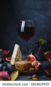 glass of red wine with grape, honey, dorblu cheese and fiigs