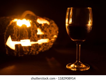 Glass Of Red Wine With Halloween Pumkin Lamp