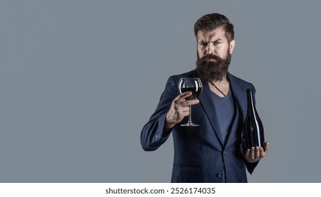 Glass of red wine in his hands. Sommelier, degustator with glass of wine, winery, male winemaker. Beard man, bearded, sommelier tasting red wine. - Powered by Shutterstock