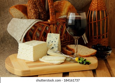 Glass Of Red Wine, Homemade Cheese, Cheese And A Basket Of Bread