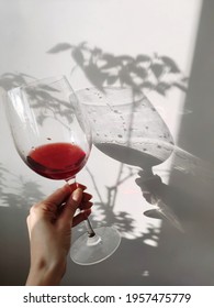 Glass Of Red Wine With Long Shadow,isolated On White Background. 