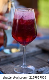 A Glass Of Red Wine And Mineral Water, Also Called Sprit.