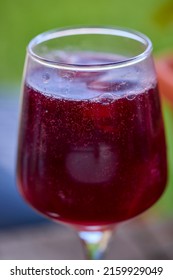 A Glass Of Red Wine And Mineral Water, Also Called Sprit.