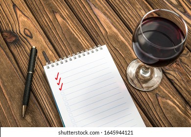 glass of red wine, Notepad, ballpoint pen on wooden table background. date, romance. - Powered by Shutterstock