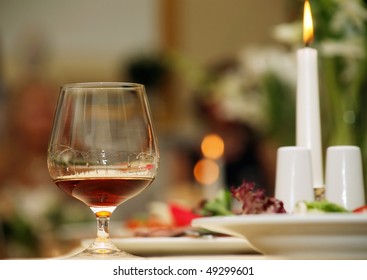 a glass of red wine is on a beautiful holiday table