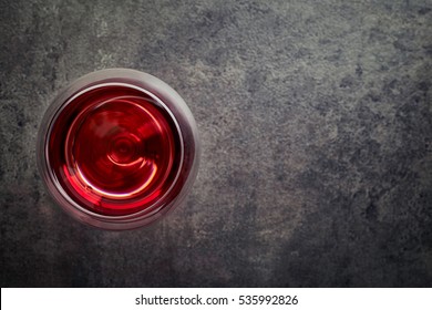 Glass Of Red Wine On Dark Gray Background From Top View