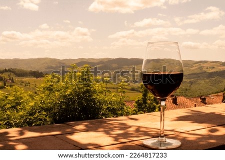 Glass of red wine on the hills of Tuscany in Italy.