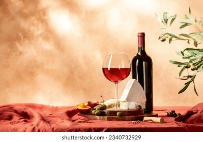 A glass of red wine on a table served with cheese and fruits, front view - Powered by Shutterstock