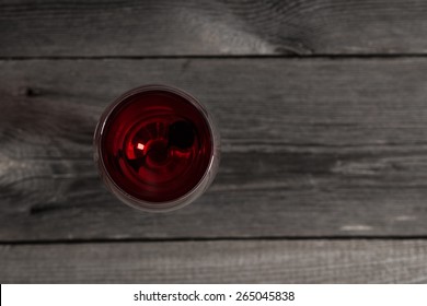 Glass Of Red Wine On Wooden Table. View From Top