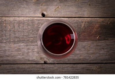 Glass Of Red Wine On Wooden Table. View From Top