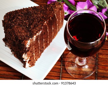 Glass of Red Wine and a Piece of Chocolate Cake
