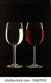 Glass Of Red Wine And White Wine Against Black Background