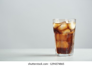 Glass of refreshing cola with ice cubes on table. Space for text - Shutterstock ID 1294374865
