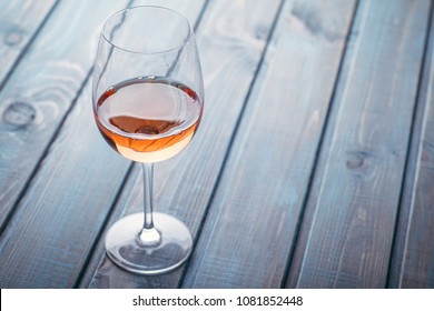 Glass Of Rose Wine On A Blue Wooden Table At A Bar