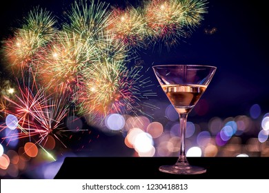 A Glass Of Rose Wine Over Light City Background And Fireworks, Christmas Festive Celebration. End Of The Year Welcome To New Year 2022. Hope Every One Have Good Life, Successful,Most Fulfilled In Life