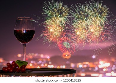 A Glass Of Rose Wine Over Light City Background And Fireworks, Christmas Festive Celebration. End Of The Year Welcome To New Year 2020. Hope Every One Have Good Life, Successful,Most Fulfilled In Life