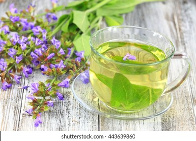 Glass Of Sage Herbal Tea Decorated  With Flowering  Sage, Lat. Salvia Officinalis