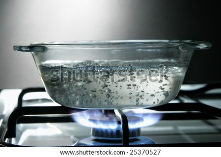 Glass saucepan on the gas stove close-up