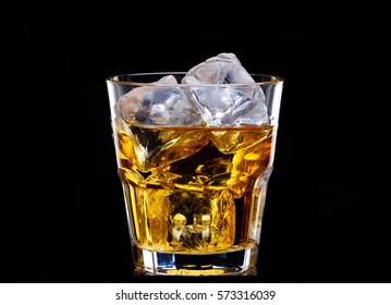 Glass Of Scotch Whiskey And Ice Over Black Background.