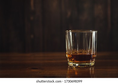 Glass Of Scotch Whiskey Neat On Top Of Wood Wet Bar. 